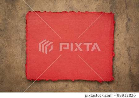 red and brown abstract - a sheet of blank Indian handmade rag paper against textured bark paper, copy space 99912820