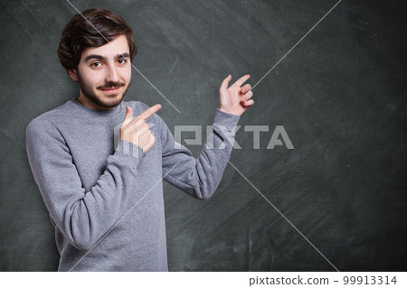 A shot of attractive man with stylish hairstyle and trendy beard dressed in casual grey sweater looking directly into camera. People, style. A shot of attractive man with stylish hairstyle and trendy beard dressed in casual grey sweater looking directly into camera. People, style. 99913314