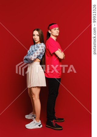 Sporty man and woman stand back to back Sporty man and woman stand back to back 99913326