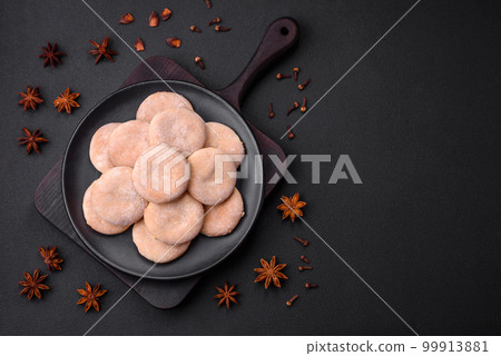Delicious fresh baked cornmeal shortcakes or cookies on a black plate 99913881