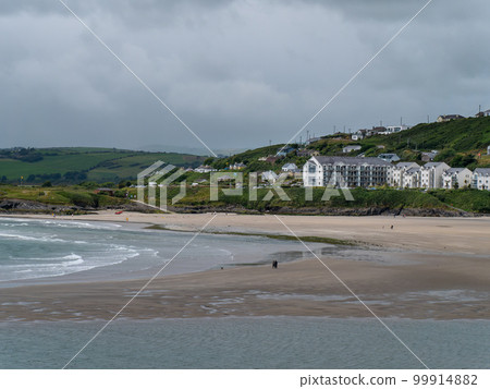 A hotel on the Atlantic Ocean. Inchydoney beach at low tide. Landscape. White concrete building near body of water. Inchydoney Island 99914882