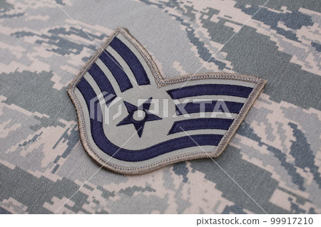 August 31, 2020. US AIR FORCE Staff Sergeant rank patch on digital tiger-stripe pattern Airman Battle Uniform (ABU) background August 31, 2020. US AIR FORCE Staff Sergeant rank patch on digital tiger-stripe pattern Airman Battle Uniform (ABU) background 99917210