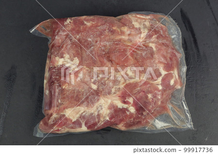 frosted mutton meat in plastic pack closeup photo on kitchen board frosted mutton meat in plastic pack closeup photo on kitchen board 99917736