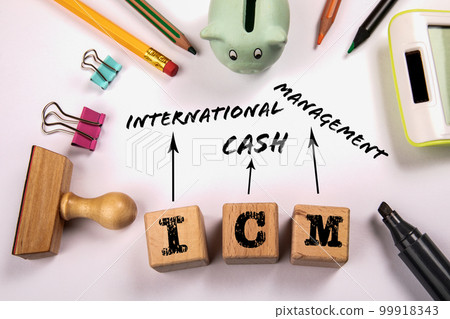 ICM - International Cash Management. Wooden blocks on a white office table ICM - International Cash Management. Wooden blocks on a white office table 99918343