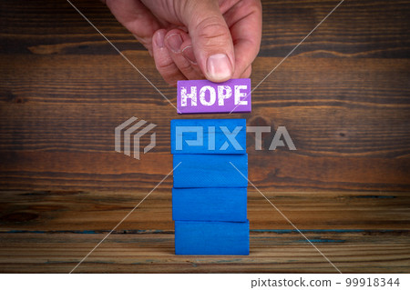 HOPE concept. Colorful blocks on a wooden texture background HOPE concept. Colorful blocks on a wooden texture background 99918344