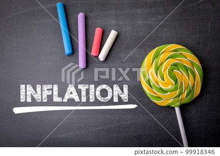 Inflation. Text, colored pieces of chalk on a dark chalkboard Inflation. Text, colored pieces of chalk on a dark chalkboard 99918346
