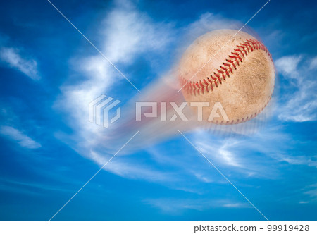 Baseball Flying Through The Air and Blue Sky. Baseball Flying Through The Air and Blue Sky. 99919428