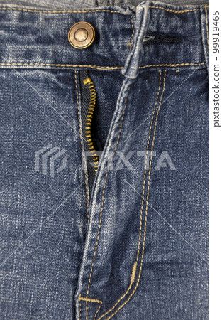 Zipper with lock on denim texture, close-up of fastener on blue jeans, metal zipper. 99919465