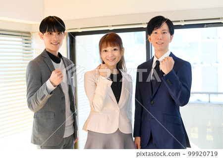 Businessmen doing a guts pose indoors Businessmen doing a guts pose indoors 99920719