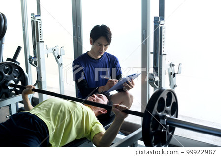 Man receiving personal training at the gym Man receiving personal training at the gym 99922987