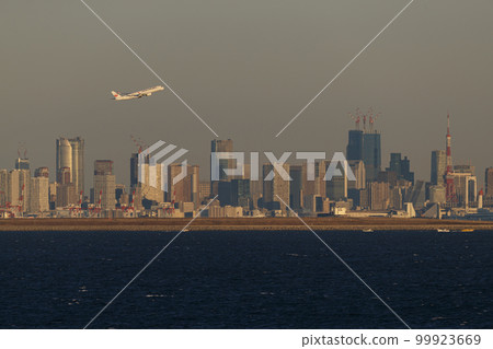 An airplane taking off with Tokyo skyscrapers in the background 99923669