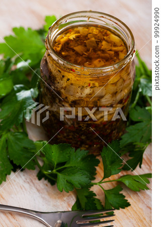 Marinated herring with onions and spice in a glass jar 99924990