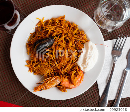 Dish of Valencian cuisine Fideua with seafood and noodles Dish of Valencian cuisine Fideua with seafood and noodles 99925038