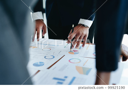 business group people are meeting and discussing budget and marketing plans in order to strategize to win over partners in order to keep the company number one. 99925190