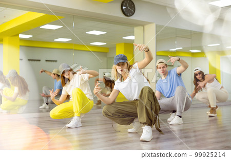 Joyous boy and girls dancing hip hop at lesson in class Joyous boy and girls dancing hip hop at lesson in class 99925214