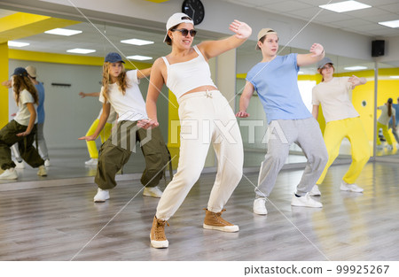 Young girl in sunglasses dancing modern dance 99925267