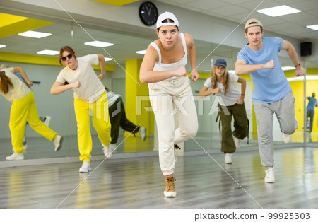 Young girl in cap dancing hip hop 99925303