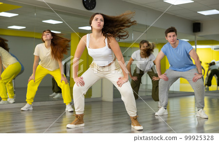 Young girl training breakdance Toprock moves in dance hall Young girl training breakdance Toprock moves in dance hall 99925328