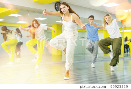 Young girl dancing modern dance in studio Young girl dancing modern dance in studio 99925329