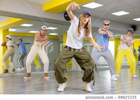 Teen girl in cap dancing modern dances 99925335