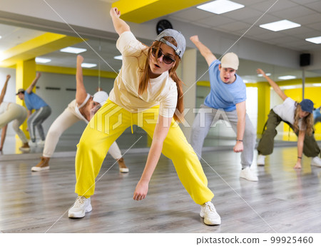 Teen girl in cap dances hip hop dances Teen girl in cap dances hip hop dances 99925460