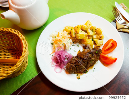 Plate with a meat dish lula-kebab and stewed potatoes. Plate with a meat dish lula-kebab and stewed potatoes. 99925652
