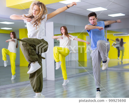 Team of dancers performing hip hop dance in ball room 99925698