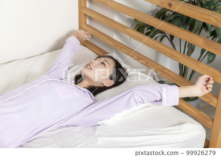 Young woman sleeping in bed Young woman sleeping in bed 99926279