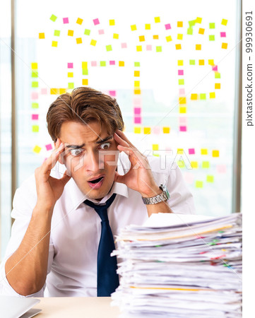 Busy businessman working in the office 99930691