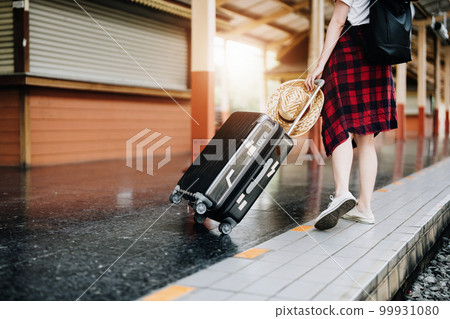 summer, relax, vacation, travel, portrait of cute Asian girl showing smile and showing joy while waiting at the train station for a summer trip summer, relax, vacation, travel, portrait of cute Asian girl showing smile and showing joy while waiting at the train station for a summer trip 99931080