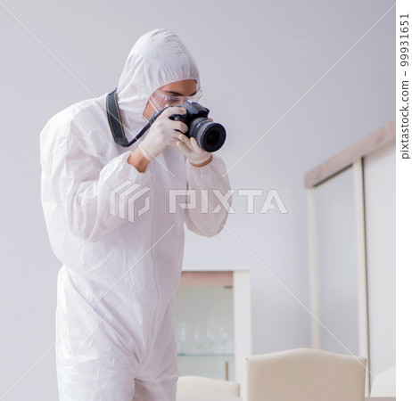 Forensic expert at crime scene doing investigation Forensic expert at crime scene doing investigation 99931651