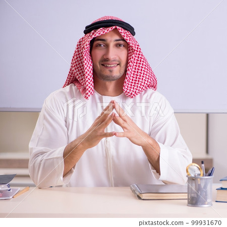 Arab teacher in front of whiteboard Arab teacher in front of whiteboard 99931670