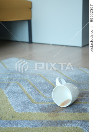cup of coffee spilled on floor  99932597