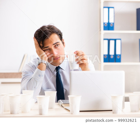 Young employee addicted to coffee 99932621