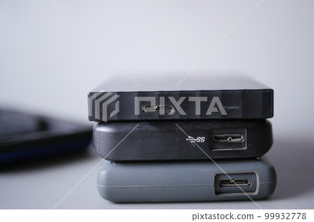 stack of external hard drives on table stack of external hard drives on table 99932778
