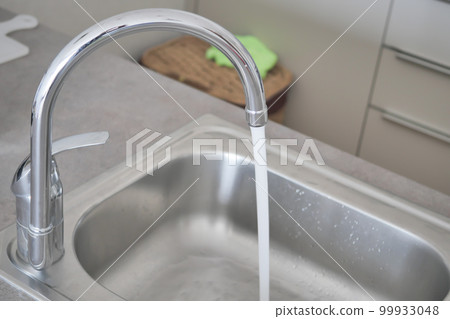 water pouring from a faucet tap slow motion  water pouring from a faucet tap slow motion  99933048