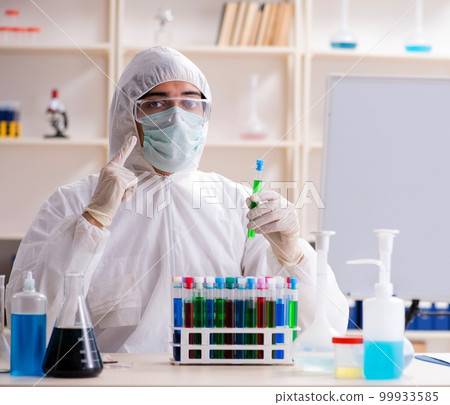 Young handsome chemist working in the lab Young handsome chemist working in the lab 99933585