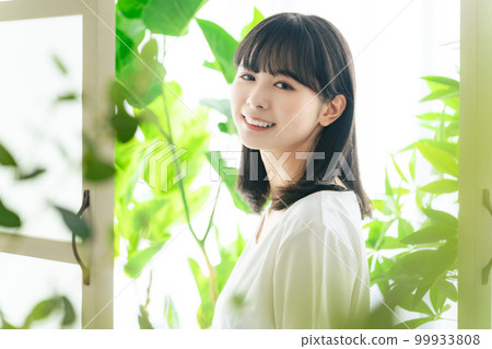 Woman surrounded by greenery Botanical image of beauty 99933808
