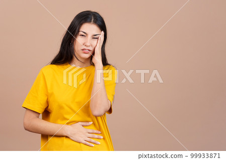 Caucasian woman gesturing bodily discomfort and headache 99933871