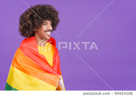 Smiling african man wrapped with a lgbt flag Smiling african man wrapped with a lgbt flag 99934206