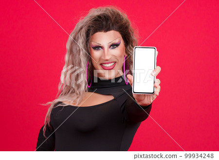 Drag queen person showing the blank screen of a mobile Drag queen person showing the blank screen of a mobile 99934248