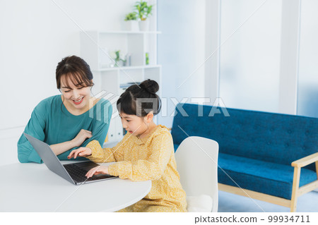 Elementary school girl looking at a computer Elementary school girl looking at a computer 99934711