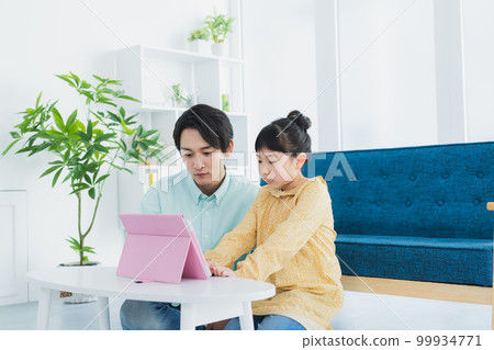 Elementary school girl looking at tablet Elementary school girl looking at tablet 99934771