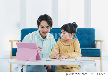 Elementary school girl looking at tablet Elementary school girl looking at tablet 99934774