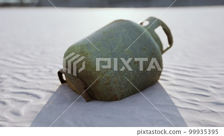 old rusted metal gas tank on the beach old rusted metal gas tank on the beach 99935395