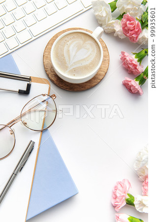 Modern white office desk table with laptop, notebook and other supplies. 99935601