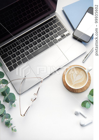 Office desk table with laptop, supplies and coffee cup Office desk table with laptop, supplies and coffee cup 99935602