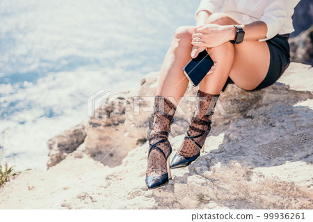 Woman sea laptop. Business woman in yellow hat freelancer with laptop working over blue sea beach. Girl relieves stress from work. Freelance, digital nomad, travel and holidays concept 99936261