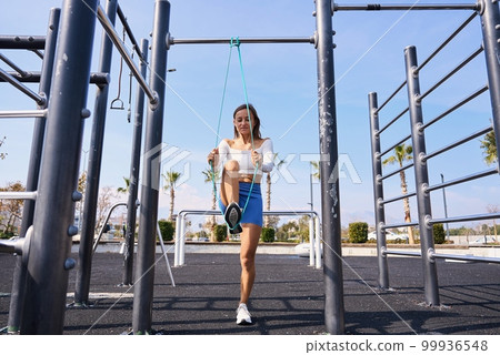 Woman doing pull-up. Strong girl in sportswear doing pull up exercise. Be H3althy. 99936548