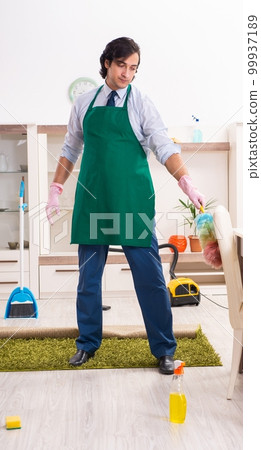 Young businessman cleaning the house 99937189